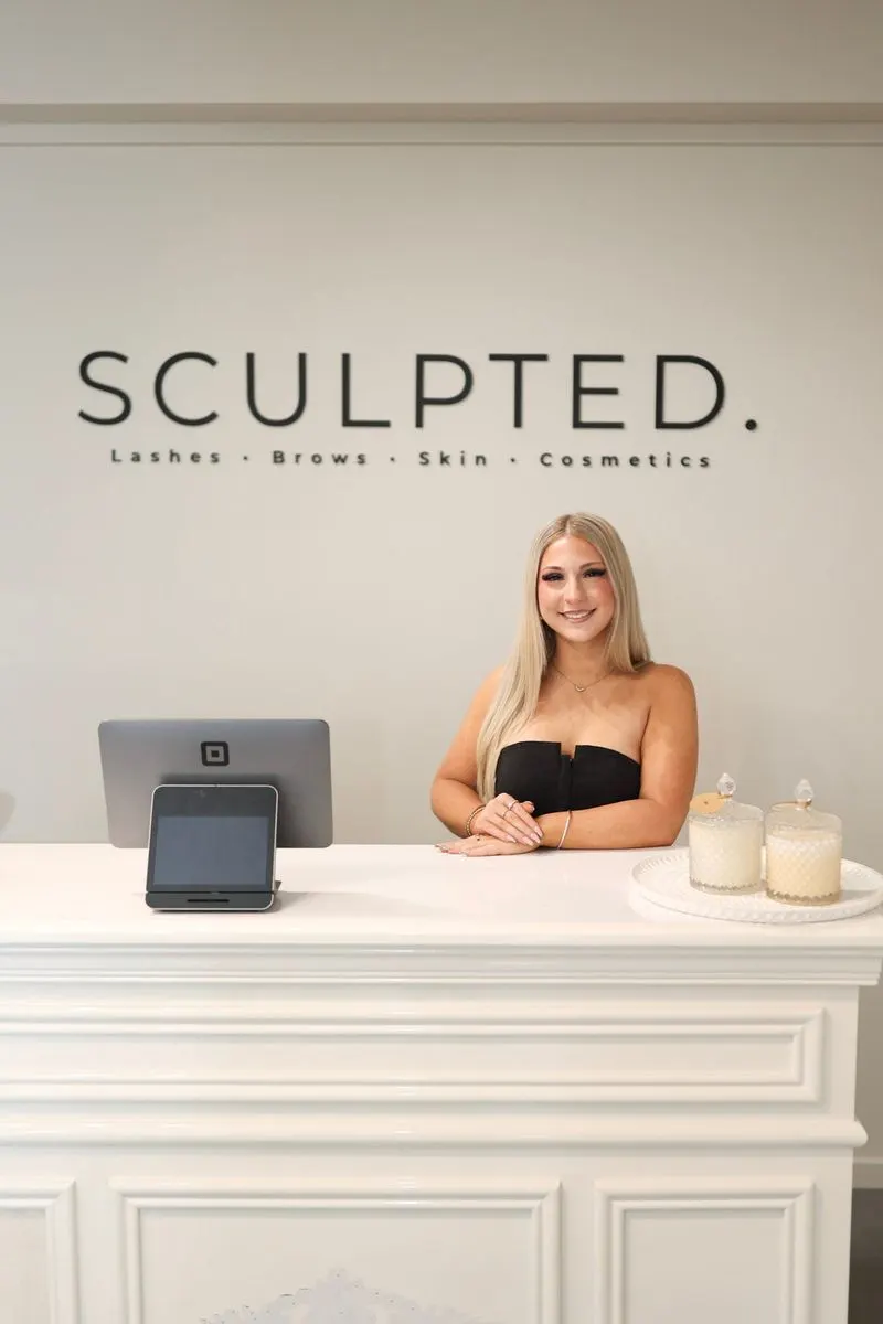 Kaylee at the Sculpted front desk
